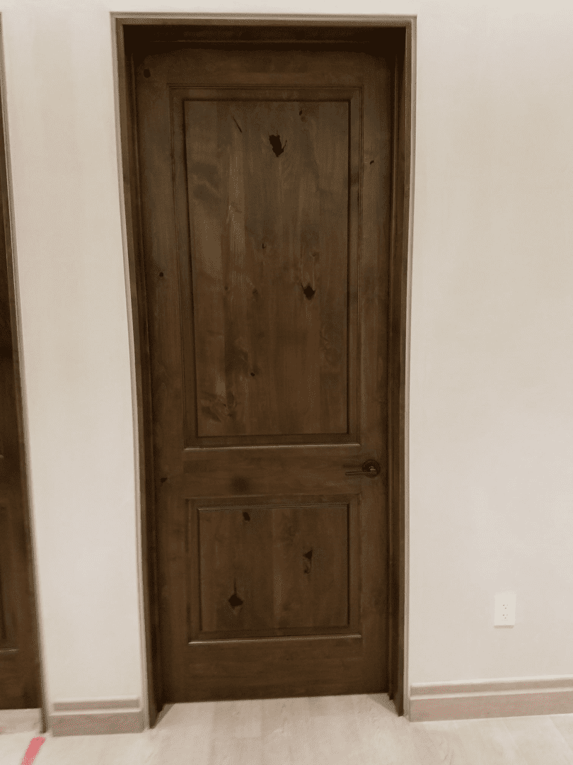 A door in the corner of a room with no one inside.