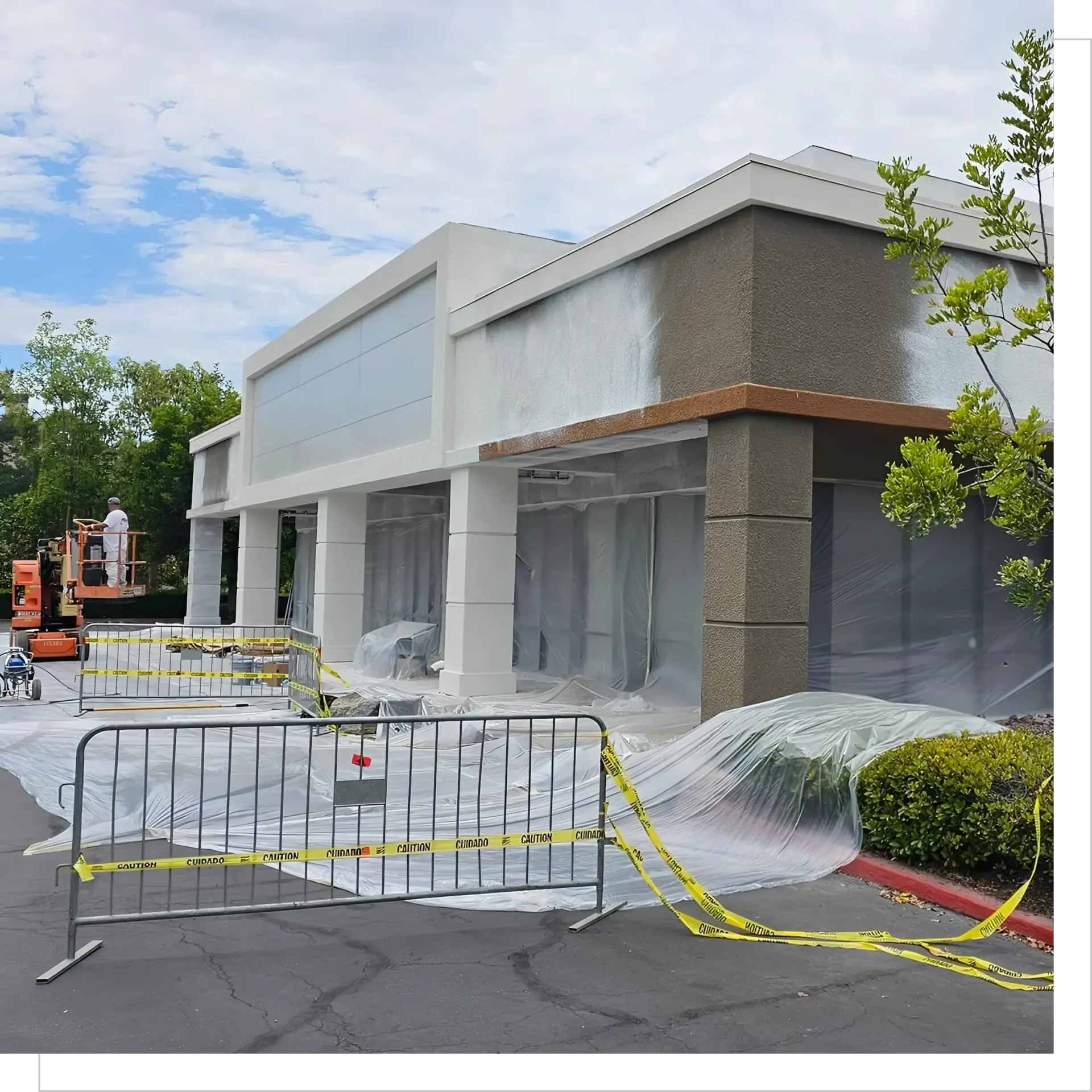 Building exterior under construction with protective coverings.